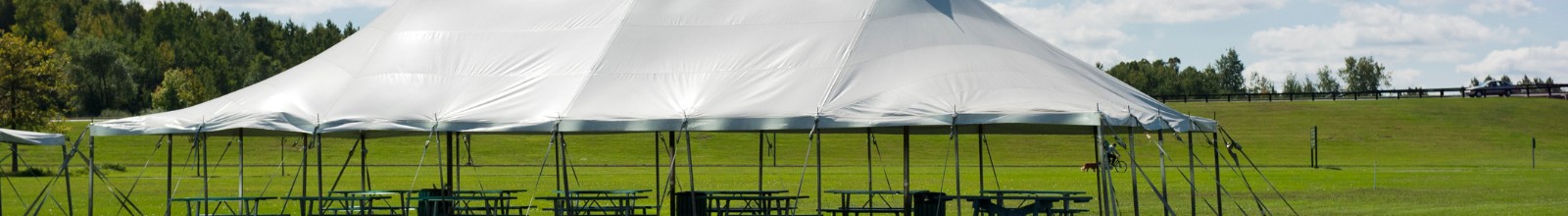 A giant tent stands in a field 