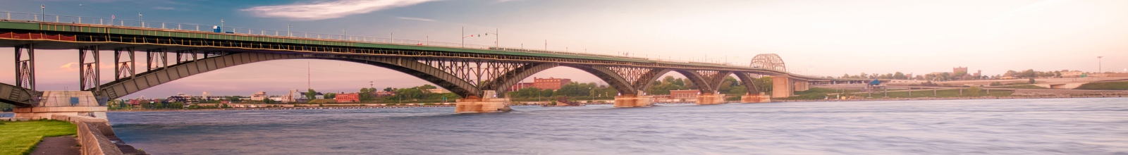 A large bridge crosses over a large river