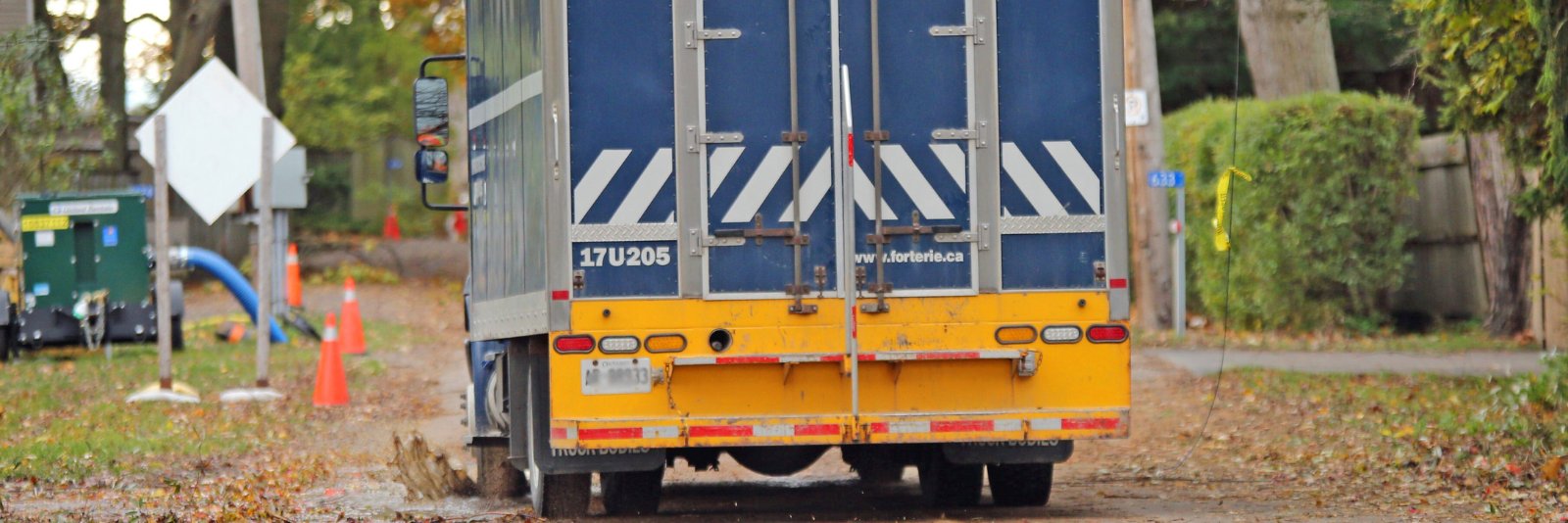 A large truck driving down a street