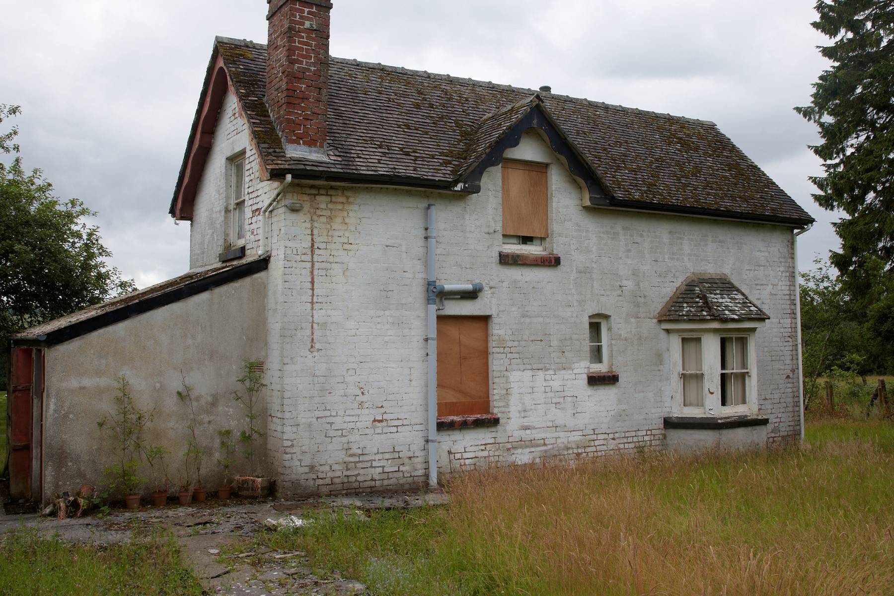 A large house with boarded up windows