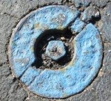 Curb Stop Picture of a circular valve that is used to shut off water